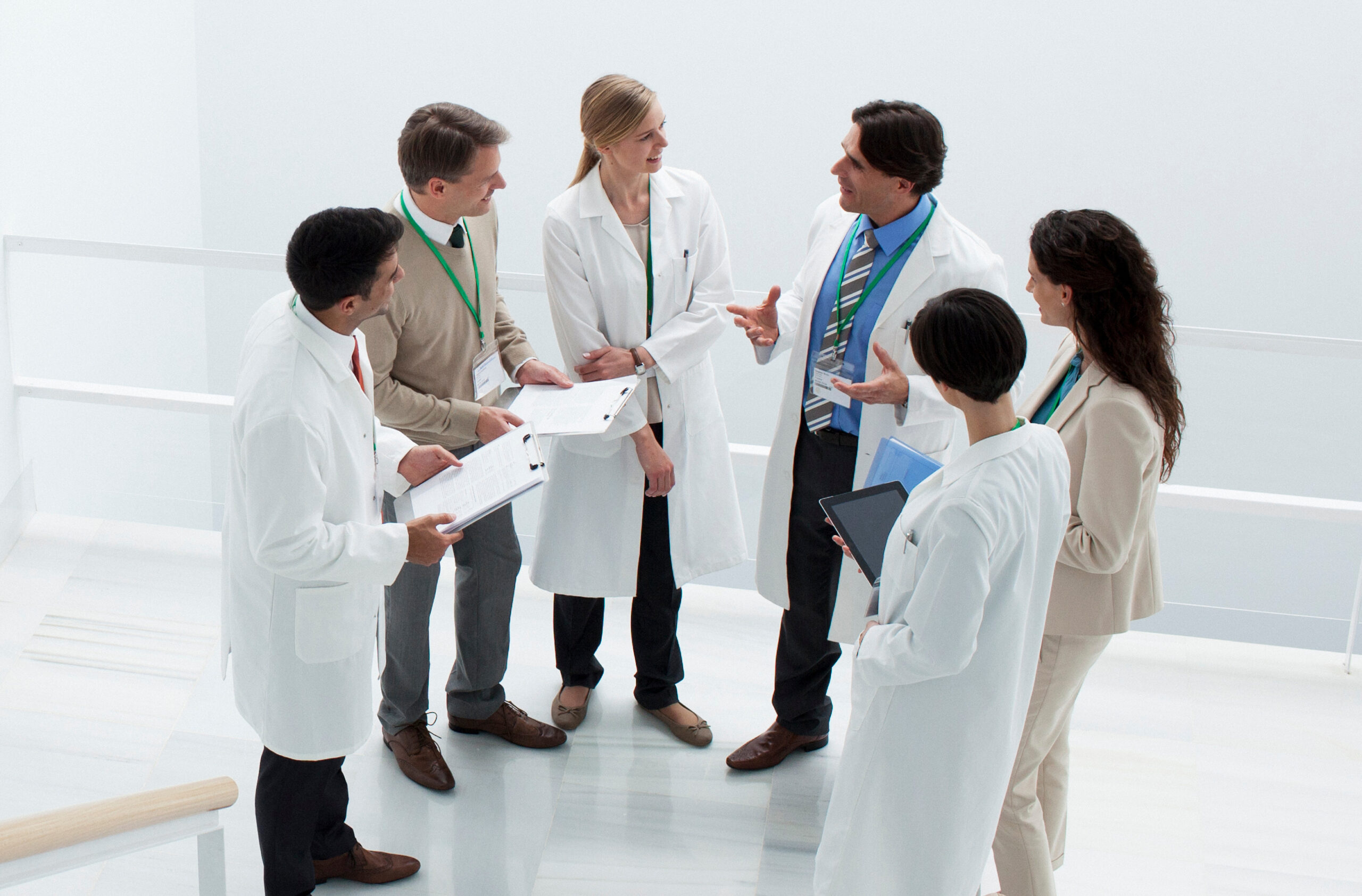 Business people and doctors meeting on landing of stairs